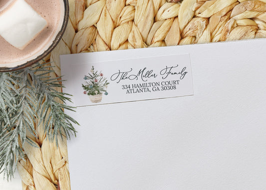 White envelope with personalized address label on a woven mat with hot chocolate and marshmallows.