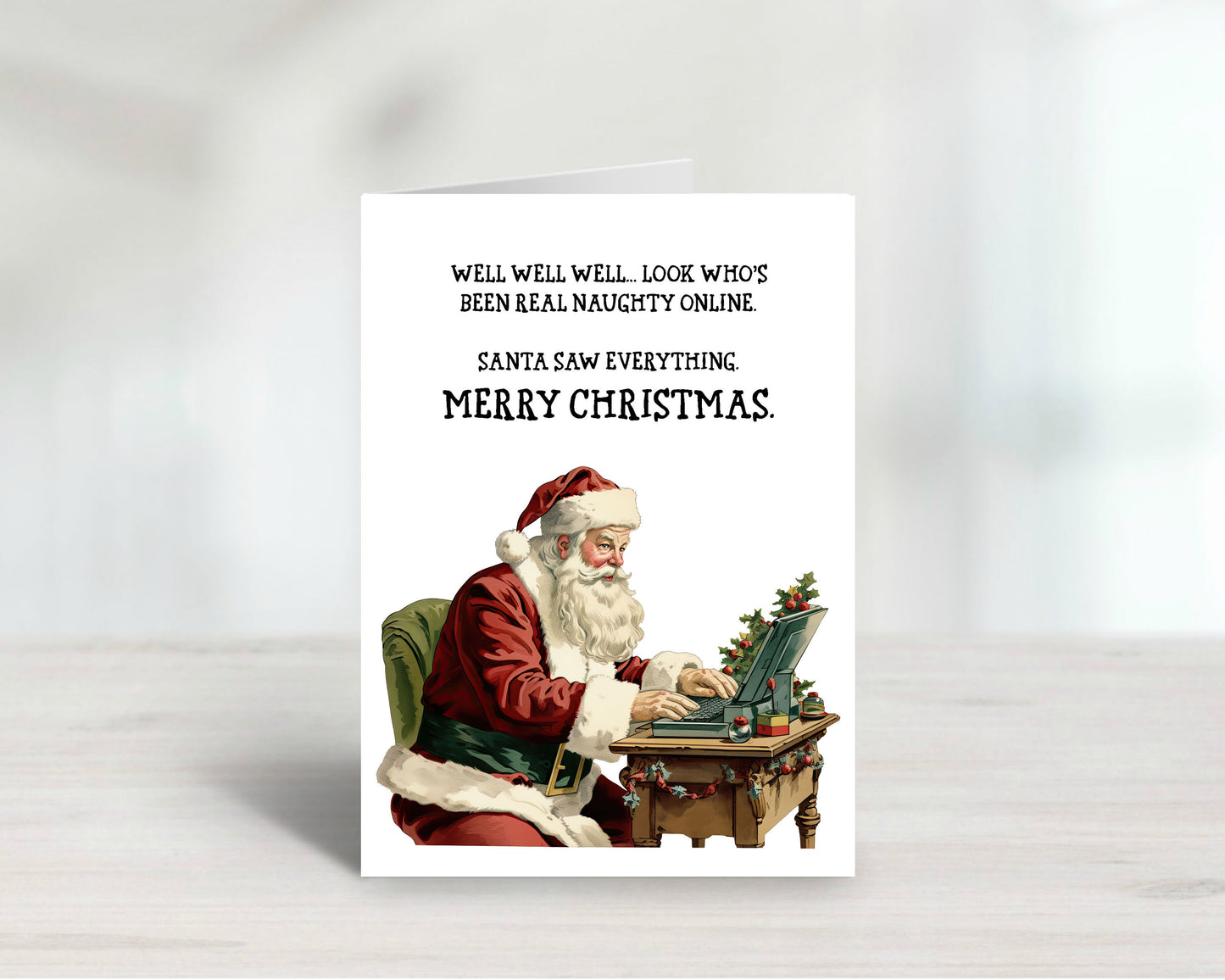 Card with Santa Claus using a laptop, text about being naughty online, on a white background