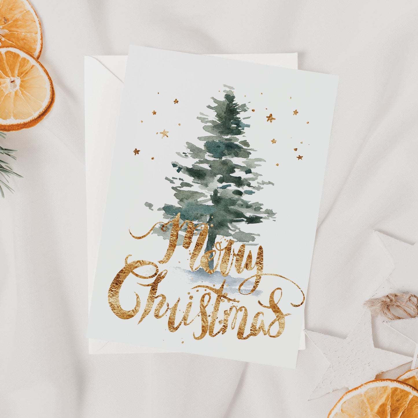 Christmas card with tree and 'Merry Christmas' text, surrounded by decorative elements on a light background.